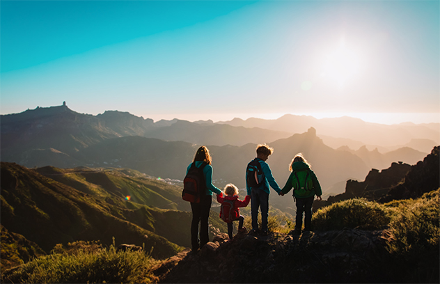 Family enjoying a mountain side view